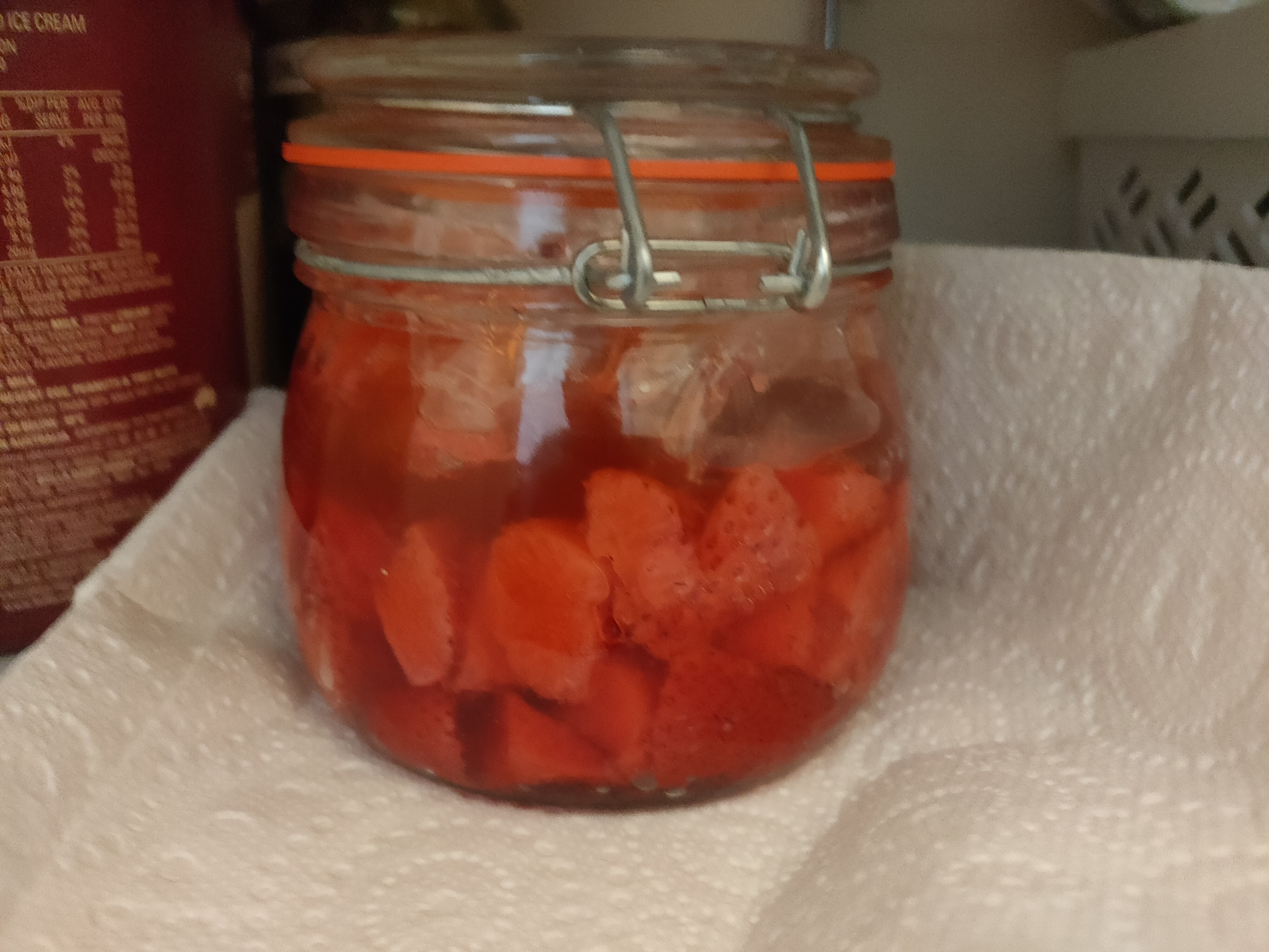 Chopped strawberries in a jar on day 3